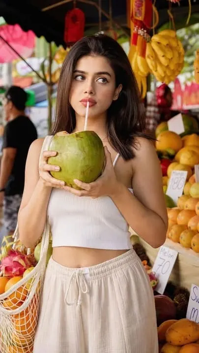 AI-generated travel influencer posing with a coconut at a market